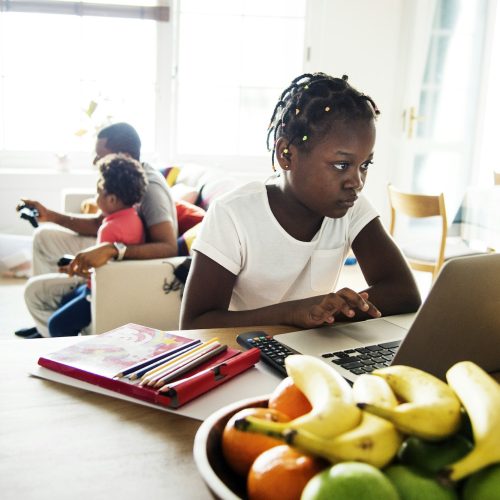 Black girl using laptop at home
